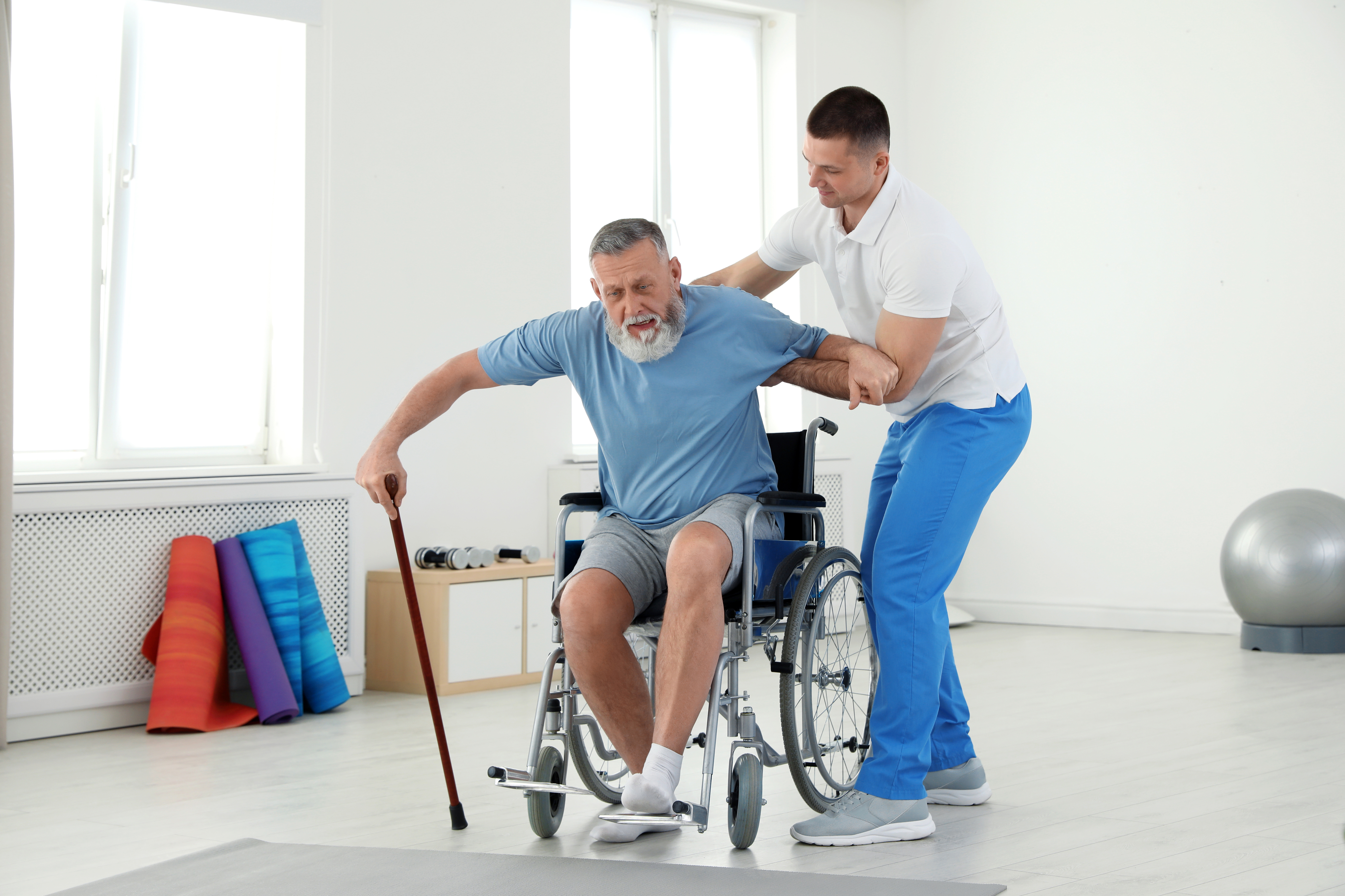 Stroke patient receiving guided rehabilitation from a clinical specialist, demonstrating expert stroke recovery support