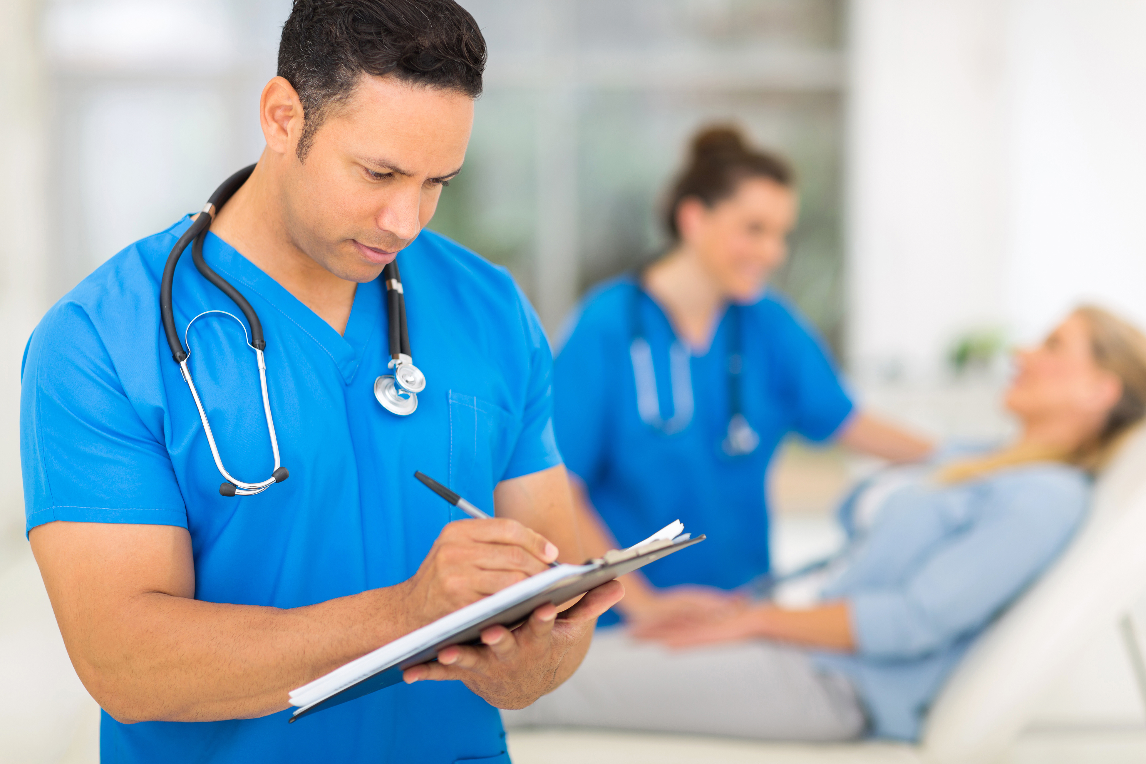 Psychiatric clinician consulting with a patient in a hospital implementing DNV NIAHO behavioural health accreditation