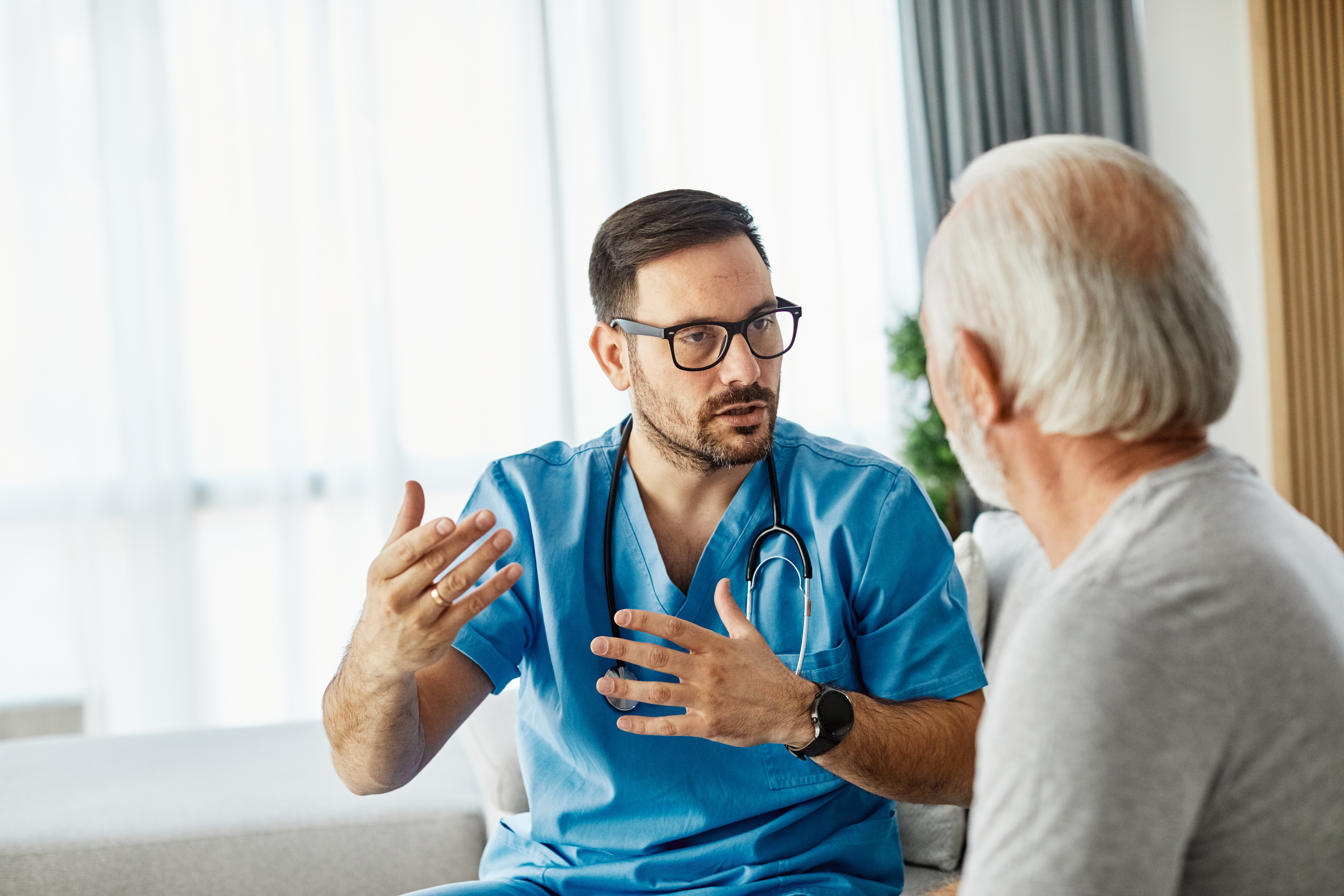 Clinician consulting with a patient about chest pain care in a hospital implementing DNV ACPC certification