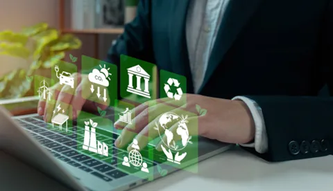 man using laptop with floating environmental icons